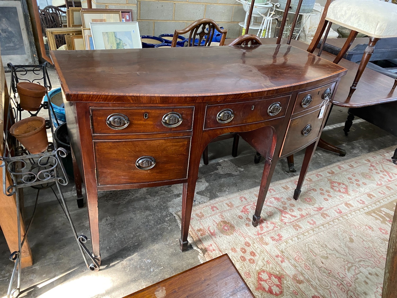 A George III satinwood banded mahogany bow front sideboard, length 138cm, depth 62cm, height 89cm